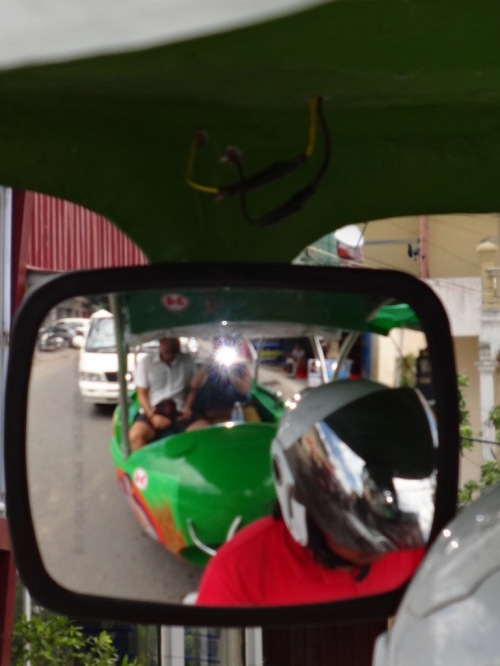 Cruising Phnom Penh's streets in our green bullet.
